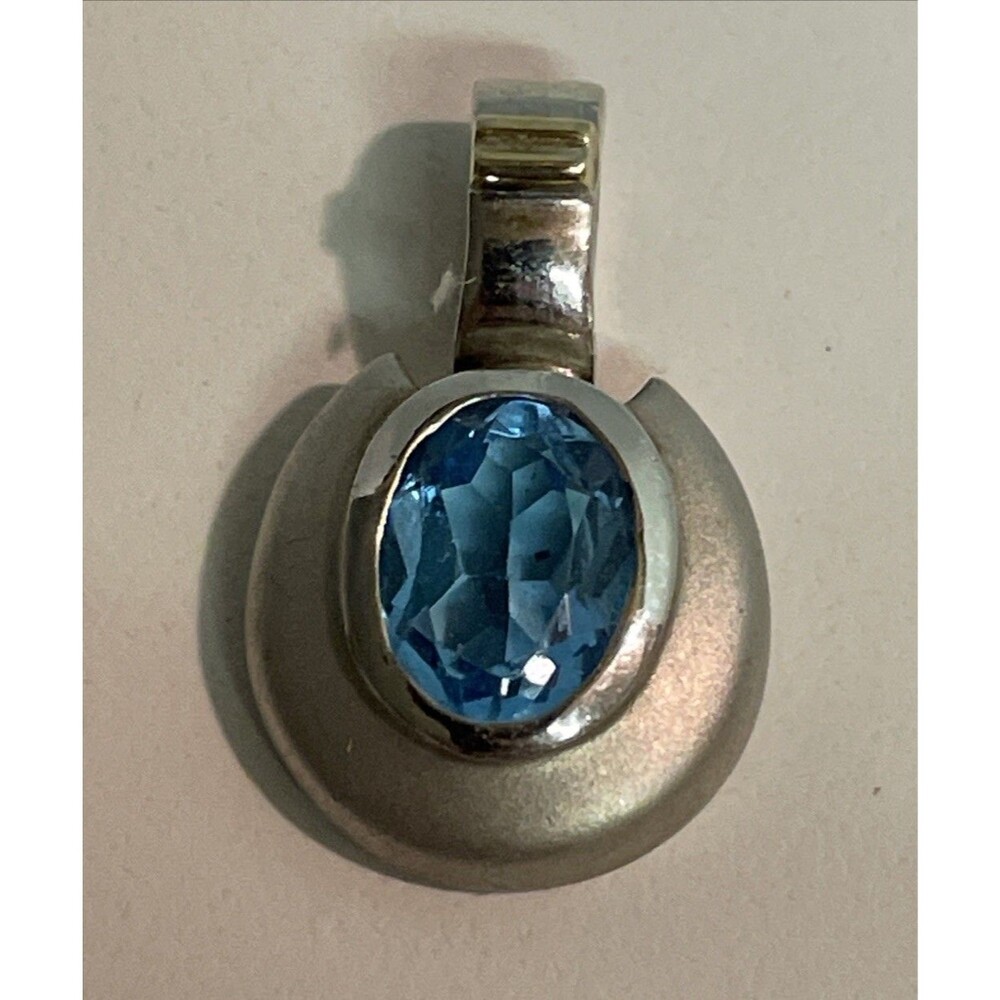 Sterling Silver and 14K Yellow Gold oval Blue Topaz Pendant